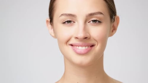 Smiling Young Woman With Hair Pulled Back