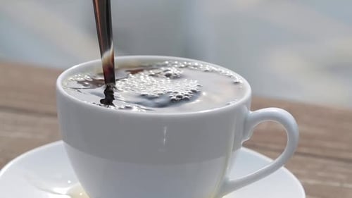 Slow motion with Last drop of the coffee fall into the cup