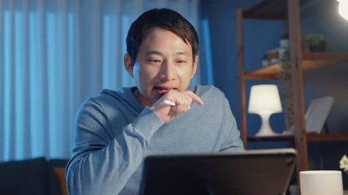 Asia businessman focus online video call meeting assignment on paperwork with colleague in tablet.