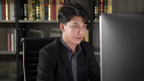 Young Adult Working at Computer in Office Setting