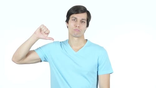 Thumbs Down by Sad Young Casual Man, White Background