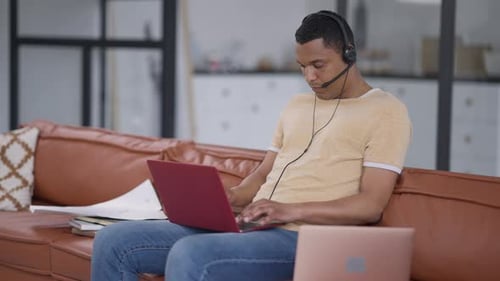 Young Adult Working at Home on Laptop