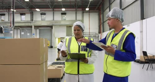 Warehouse workers discussing together