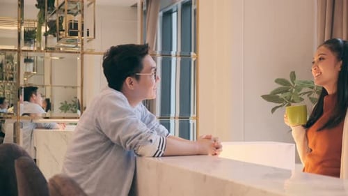 Young Adults Chatting in Modern Cafe