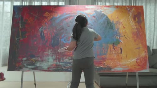 Girl Creates Abstract Painting on Large Canvas