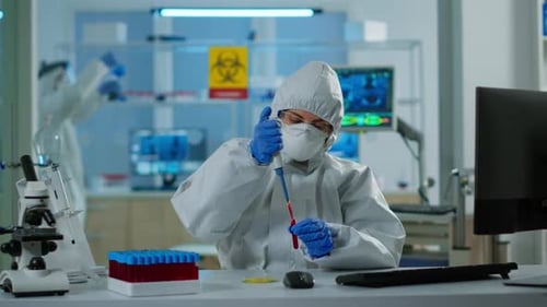 Scientist Extracts Liquid in Modern Laboratory Setting