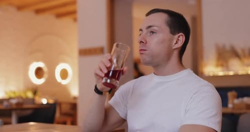 Man Drink Juice in Cafe