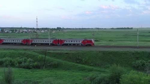 Modern Train Travels Through Green Rural Landscape