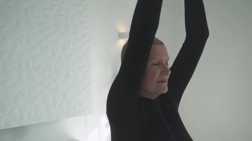 Senior Woman Practicing Yoga Indoors