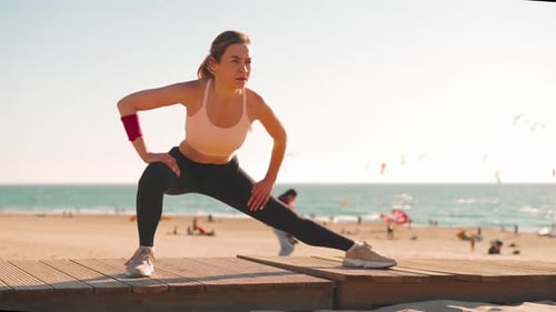 Woman Stretching at Beach on Sunny Day