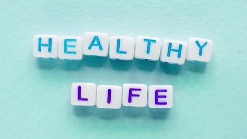 Cubes Spelling Healthy Life Message on Blue Background