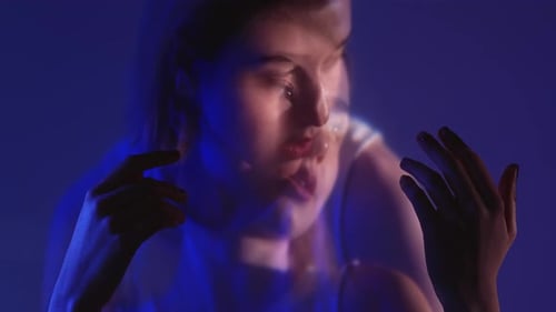 Close Up of Young Adult Against Blue Background