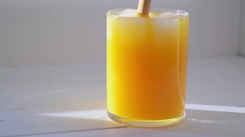 Orange Beverage Drink with Ice and Straw