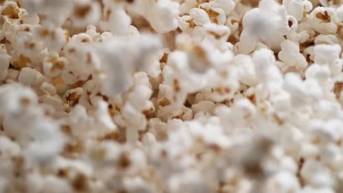 Camera follows popcorn jumping. Slow Motion.
