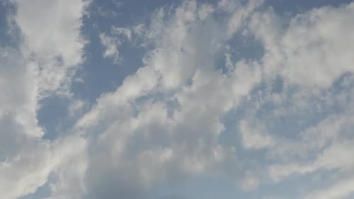 White Clouds Drifting Across a Light Blue Sky