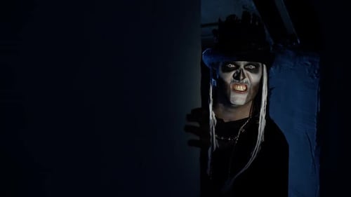 Sinister Man with Halloween Skeleton Makeup Appears From Dark Corner Shouting, Trying To Scare