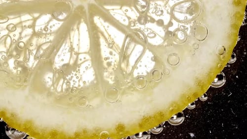 Close-Up Lemon Slice with Bubbles in Water