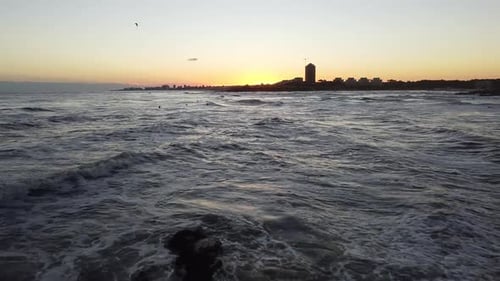 Coastal City Waves at Sunrise