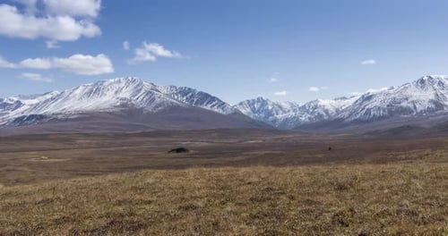 Timelapse of Sun Movement on Crystal Clear Sky with Clouds Over Snow Mountain Top