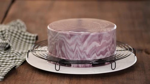 Close Up of Professional Chef Covering the Glaze Cake. Woman Decorating Cakes with Mirrored Glaze.