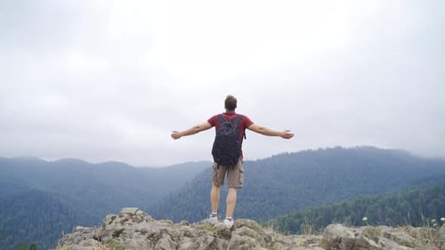 The man walking on the summit. Feeling of freedom.
