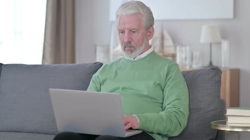 Senior Man Working on Laptop at Home