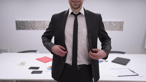 Unrecognizable Confident Young Businessman Standing in Office Buttoning Jacket