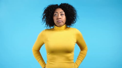 Woman Rolling Eyes Comically on Blue Background