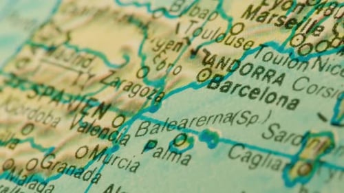 Slow tracking shot over Barcelona and Palma, Mallorca on a globe