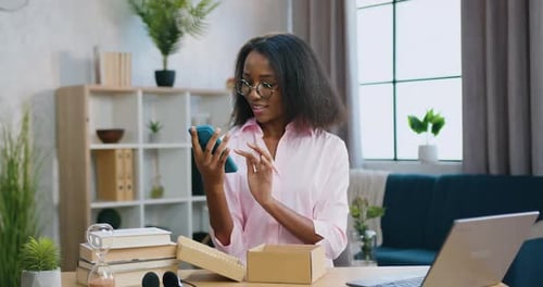 Happy Woman Unboxes New Smartphone at Home