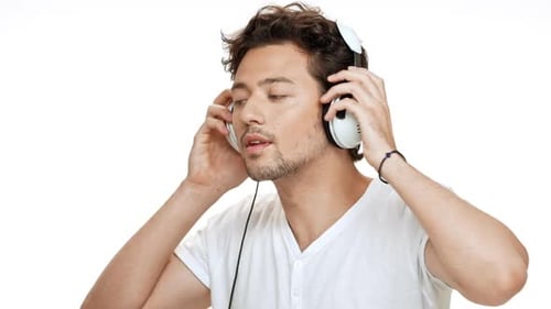 Man Enjoys Music with Headphones in Studio