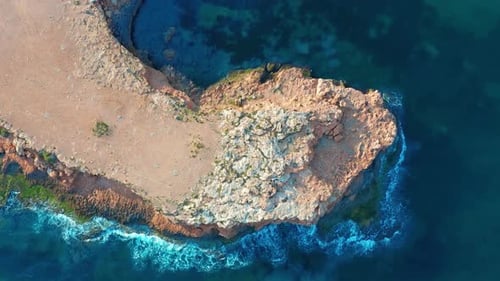 Aerial View. Down View Moving Forward Over Mediterranean Coastline Cliff Edge with White Sand and