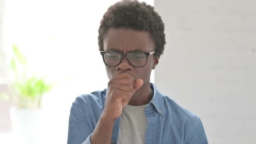 Portrait of Sick Young African Man Coughing