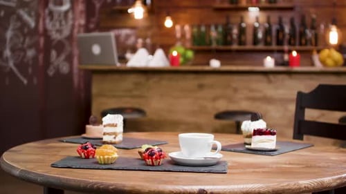 Cakes and Coffee on Wooden Table in Cafe