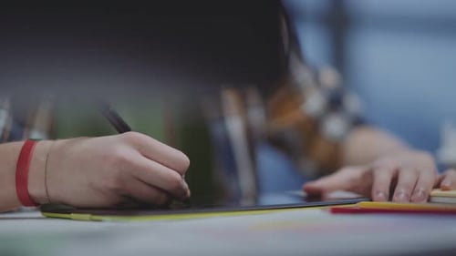 Person Drawing on a Tablet with a Stylus