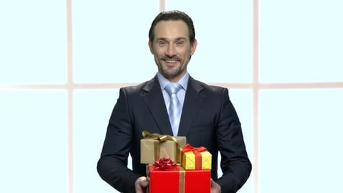 Happy Man Holding Wrapped Birthday Gifts