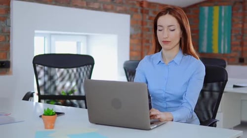 Woman working on Laptop in Modern Office