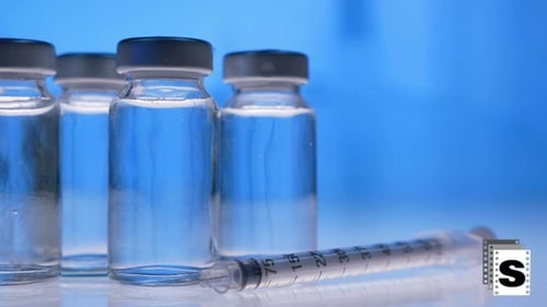 Vaccine Vials and Syringe Close Up in Lab