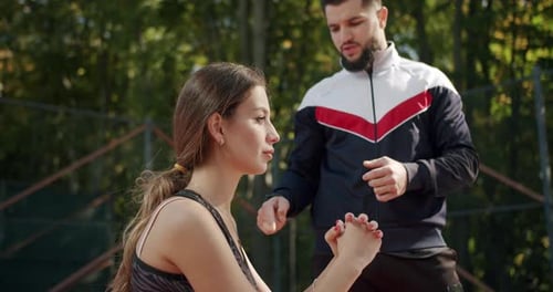 Woman Working Out with Trainer in the Park