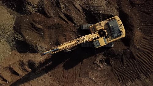 Excavator Working at Construction Site Aerial View