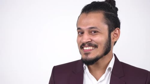 Smiling Man with Hair Bun Wearing Suit