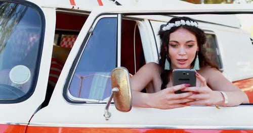 Woman Using Phone in Van Window