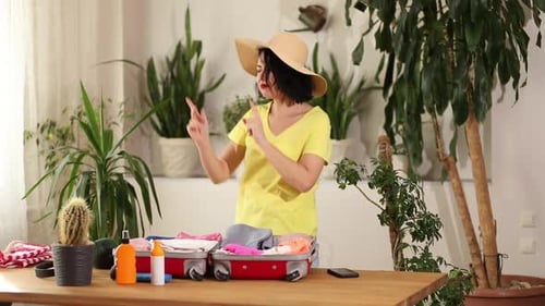 Woman Packs Suitcase and Dances in Sunny Room