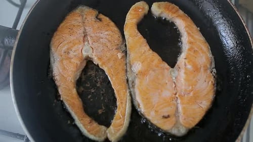 Salmon Steaks Frying in a Pan