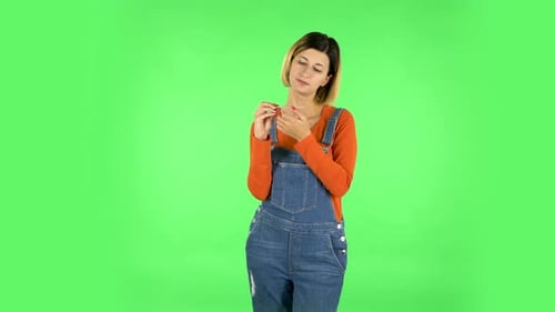 Girl Makes Herself Manicure with Pink Nail File. Green Screen