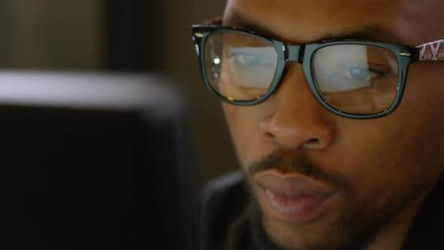 Male executive working on computer at desk in office 4k