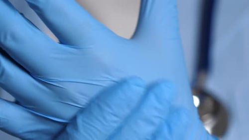 Hands Wearing Blue Medical Gloves Giving Thumbs Up