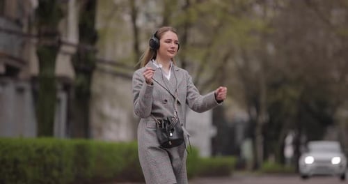 Slow Motion Woman Wearing Headphones Walking in the City