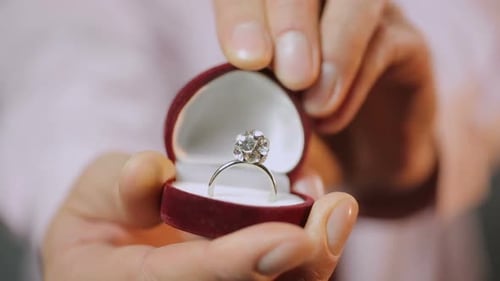 Man Making Marriage Proposal, Close-Up of Hands Showing Beautiful Silver Ring