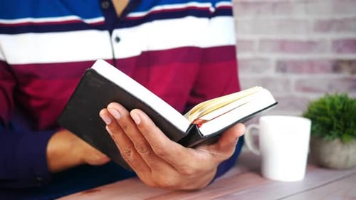 Hands Turn Pages of Blank Notebook in Home
